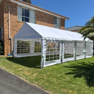 White event marquee with window walls installed beside house for backyard party hire in Pakenham VIC